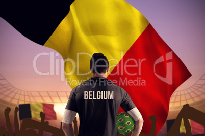 Composite image of belgium football player holding ball