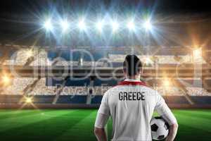 Composite image of greece football player holding ball