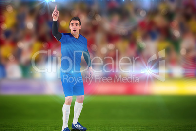 Composite image of football player raising his hand