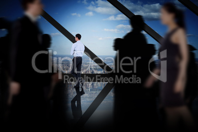 Composite image of business people walking in a blur