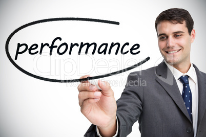 Businessman writing the word performance