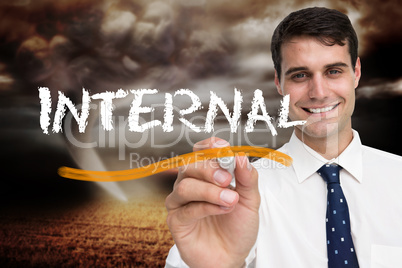 Businessman writing the word internal
