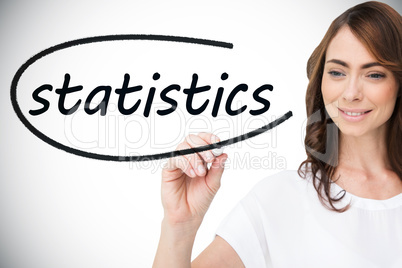 Businesswoman writing the word statistics