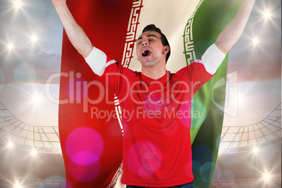 Composite image of excited football fan cheering holding iran fl