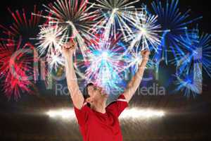 Composite image of excited football player cheering