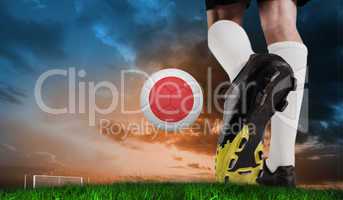 Composite image of football boot kicking japan ball