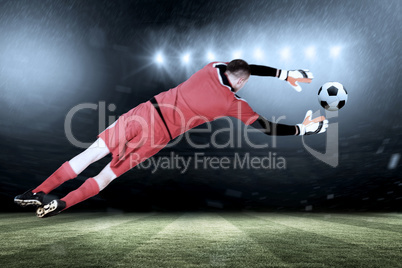 Composite image of fit goal keeper jumping up