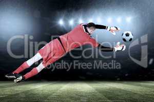 Composite image of fit goal keeper jumping up