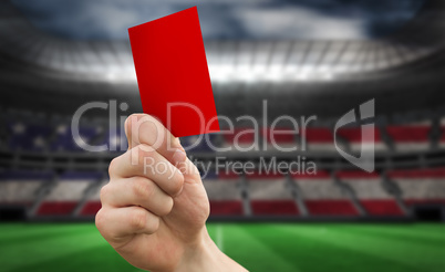 Composite image of hand holding up red card