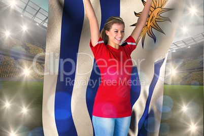 Composite image of cheering football fan in red holding uruguay