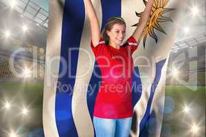Composite image of cheering football fan in red holding uruguay