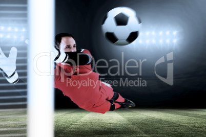 Composite image of fit goal keeper jumping up