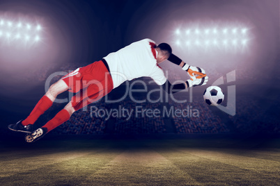 Composite image of fit goal keeper jumping up