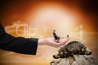 Composite image of businesswoman sitting on swivel chair with fe