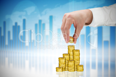 Composite image of businessman holding coins