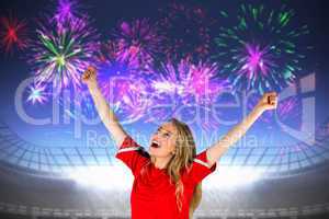 Composite image of cheering football fan in red