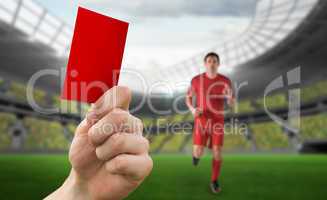 Composite image of hand holding up red card