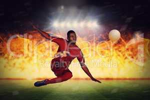 Composite image of football player in red kicking