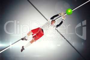 Composite image of goalkeeper in white jumping up