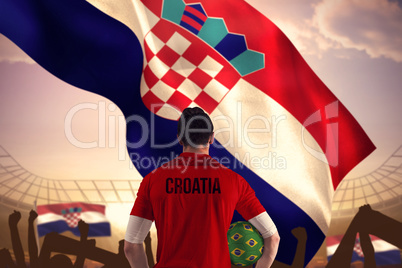 Composite image of croatia football player holding ball