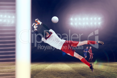 Composite image of fit goal keeper jumping up