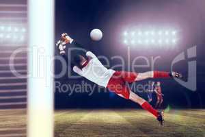 Composite image of fit goal keeper jumping up