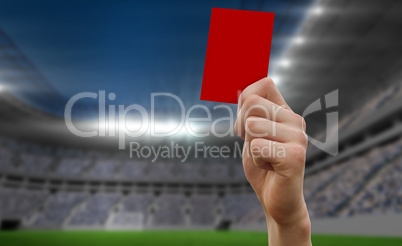 Composite image of hand holding up red card