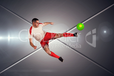Composite image of fit football player playing and kicking