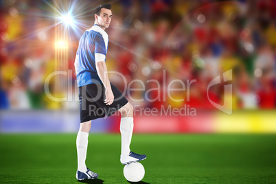 Composite image of handsome football player in blue jersey