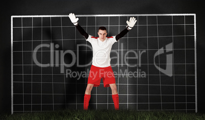 Composite image of goalkeeper in red and white ready to catch Composite image of goalkeeper in red and white ready to catch