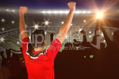 Composite image of excited football player cheering