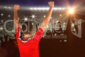 Composite image of excited football player cheering