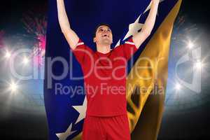 Composite image of excited football player cheering