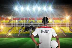 Composite image of ghana football player holding ball