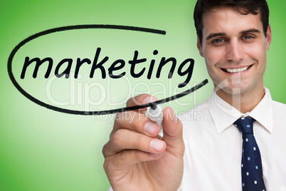 Businessman writing the word marketing