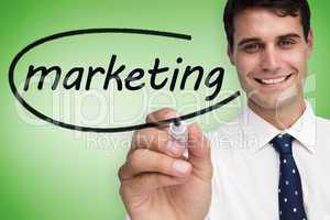 Businessman writing the word marketing