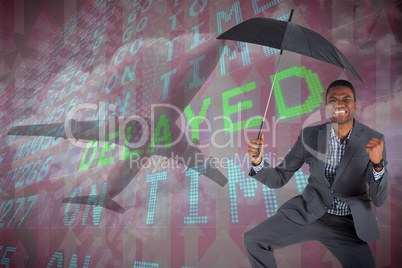 Composite image of businessman cheering and holding umbrella
