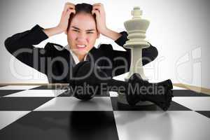 Composite image of stressed businesswoman with hands on her head