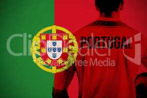 Composite image of portugal football player holding ball