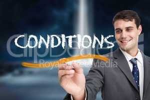 Businessman writing the word conditions