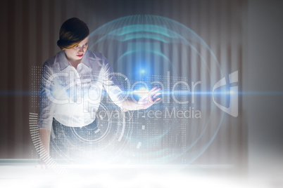 Composite image of redhead businesswoman using interactive desk