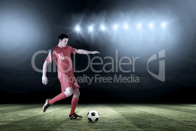 Composite image of football player in red kicking