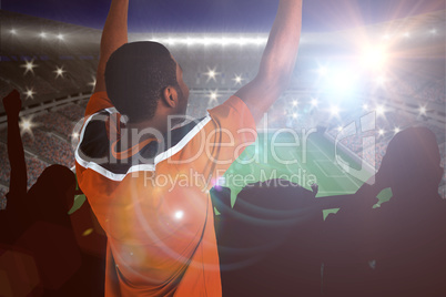 Composite image of cheering football fan in orange jersey