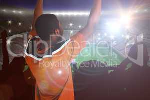 Composite image of cheering football fan in orange jersey
