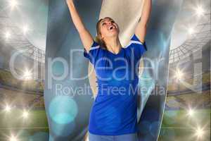 Composite image of cheering football fan in blue jersey holding