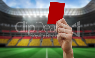 Composite image of hand holding up red card