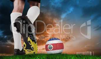 Composite image of football boot kicking costa rica ball