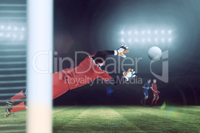 Composite image of fit goal keeper jumping up