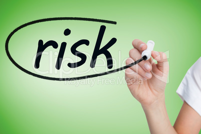 Businesswoman writing the word risk