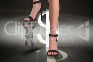 Composite image of female feet in black sandals stepping on tiny